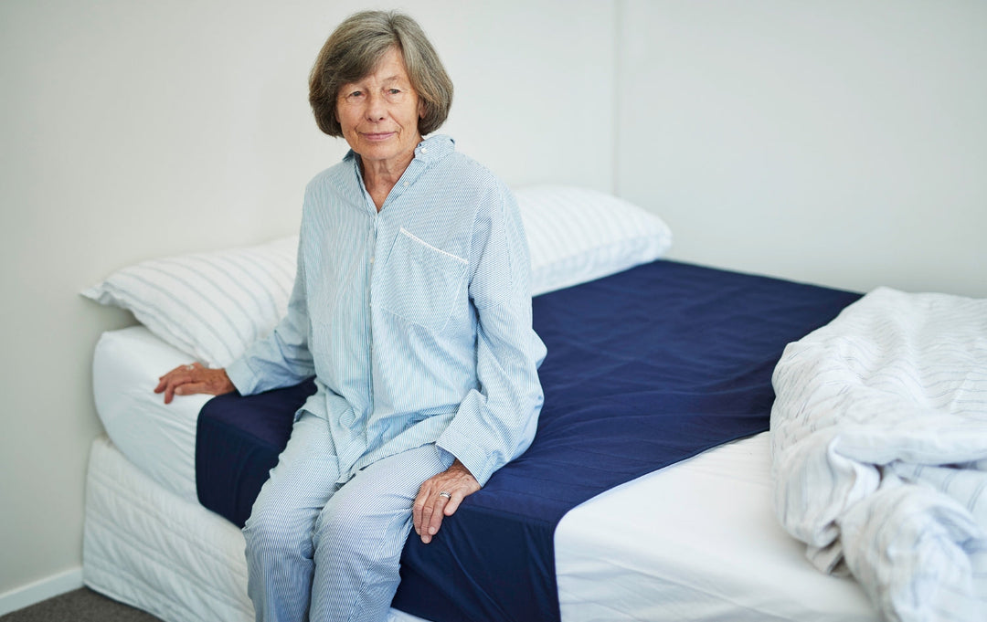 Washable waterproof Brolly Sheets bed pad with wings and cotton top in navy color.
