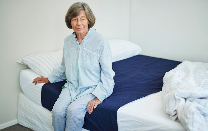 Washable waterproof Brolly Sheets bed pad with wings and cotton top in navy color.