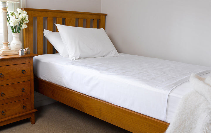 White Brolly Sheets bed pad with wings for King Single beds, featuring a soft, absorbent fabric design.