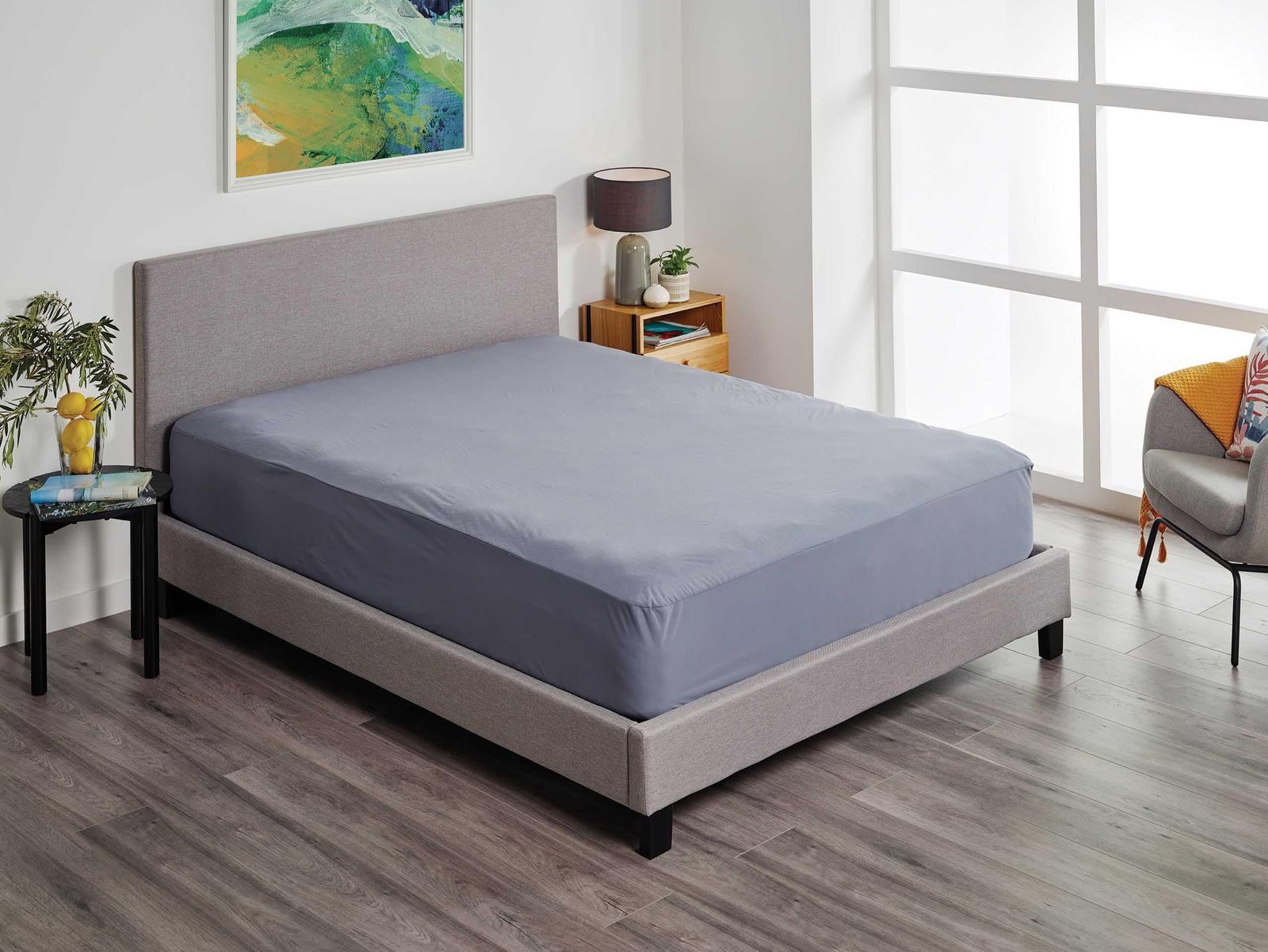 SleepCorp® Protect-A-Bed Fusion 2-in-1 fitted sheet and protector in soft fabric, showcasing a cozy bedding setup.